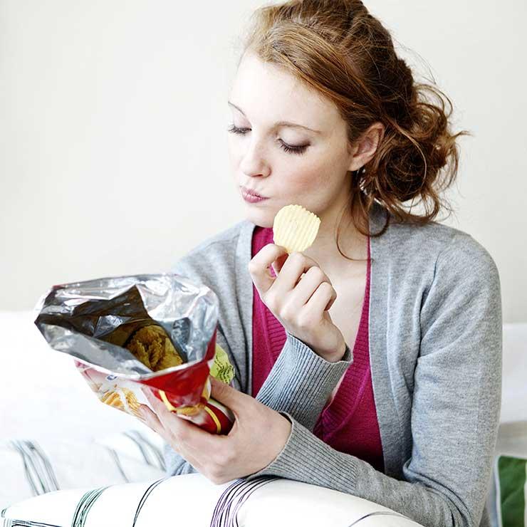 Woman eating Chips