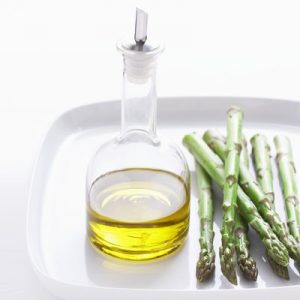 Asparagus and olive oil on plate, close-up