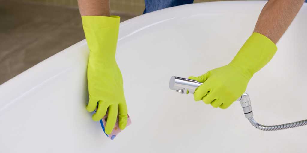 Hands cleaning bathtub