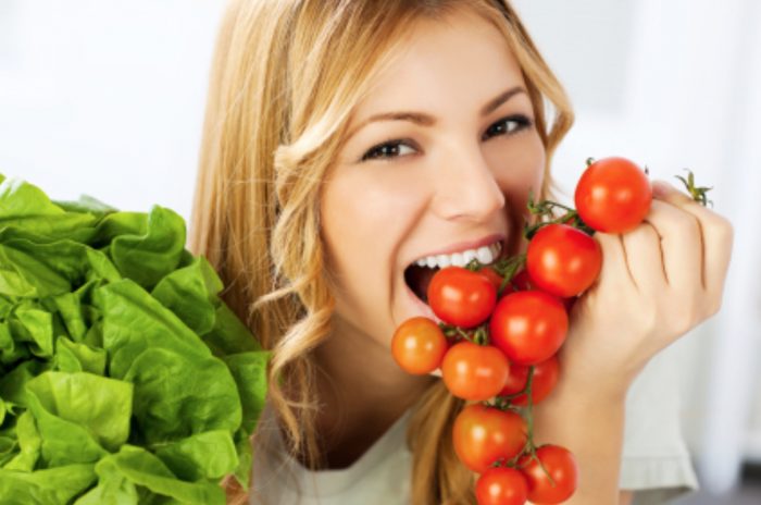 Woman eating Tomatoes