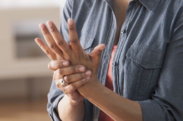 Older-Black-woman-rubbing-her-hands--Arthritis