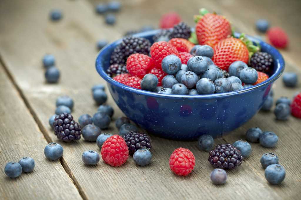 A bowlful of delicious organic berries. Strawberries, blackberries, blueberries and raspberries. Shallow dof
