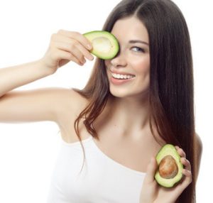 portrait of attractive caucasian smiling woman isolated on white studio shot with avocado